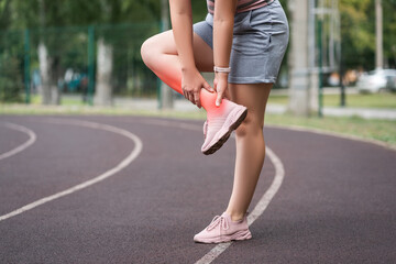 Achilles tendon injury, callus on the heel while running, foot pain, woman suffering from feet ache on a sports ground, podiatry concept - 749944293