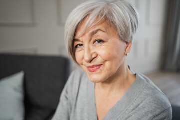 Fototapeta na wymiar Portrait of confident stylish european middle aged senior woman. Older mature 60s lady smiling at home. Happy attractive senior female looking camera close up face headshot portrait. Happy people
