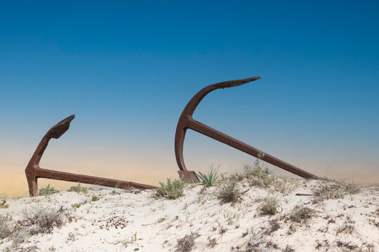 The photo captures the evocative Cemetery of Anchors in Santa Luzia, Portugal, a poignant memorial to the region's once-thriving tuna fishing industry.