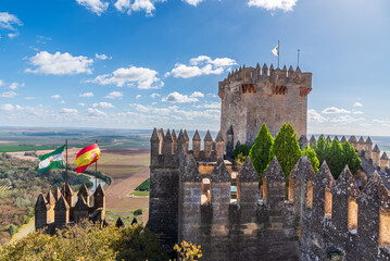 Tower of homage, walls and battlements with the flags of Spain and Andalusia in the castle of...