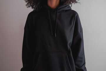 A black hoodie on a simple, solid background. Hoodie mockup. Ghost mannequin