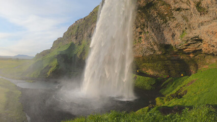 The Seljalandsfoss waterfall on the south coast of Iceland bathed in the otherworldly light of the...