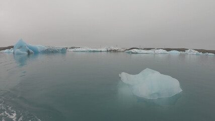 View from a boat of Jokulsarlon Glacier Lagoon in Iceland. Melting icebergs floating.
