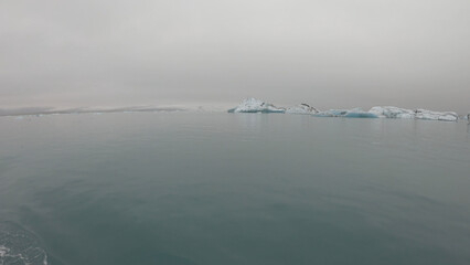 View from a boat of Jokulsarlon Glacier Lagoon in Iceland. Melting icebergs floating.