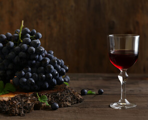 fresh grapes and red wine in a glass