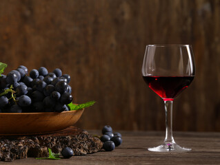 fresh grapes and red wine in a glass
