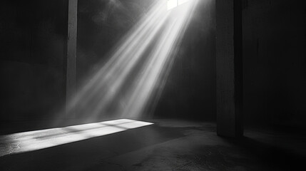A beam of light shines through a window, illuminating a dark room with stark contrast