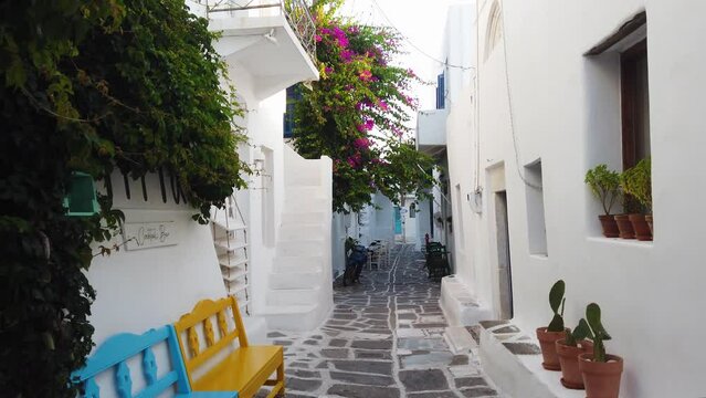 Naoussa typical white street leading to sea with sunshine, small village on Paros island, Greece