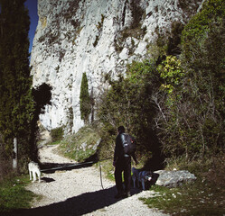 hiker on the mountain with his pet. mountaineer contemplating the landscape, Roquefixade in France