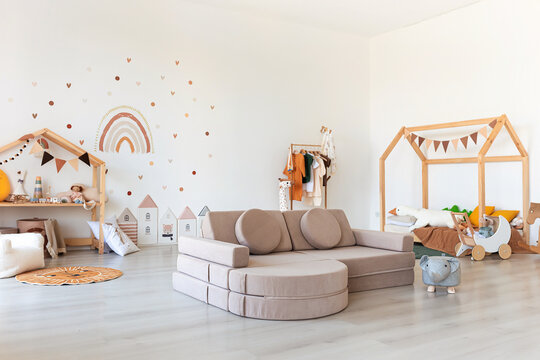 Kids room interior in contemporary, Scandinavian style. Wooden bed, sofa and toys. Cozy room for child.