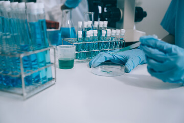 Fototapeta premium Scientist works with a pipette and a test tube. Scientific laboratory of biotechnology, development of medicine and research in chemistry, biochemistry and experiments.