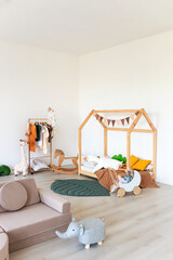 Kids room interior in contemporary, Scandinavian style. Wooden bed, sofa and toys. Cozy room for child. - 749983649