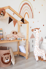 Kids room interior in contemporary, Scandinavian style. Wooden bed, sofa and toys. Cozy room for child. - 749984094