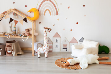 Kids room interior in contemporary, Scandinavian style. Wooden bed, sofa and toys. Cozy room for child. - 749984203