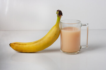 one glass of banana juice on a white glass