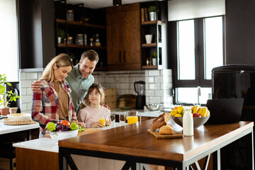 Family bonding during breakfast in a sunlit modern kitchen