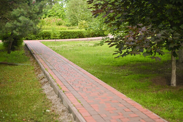 the path is lined with bricks in the park