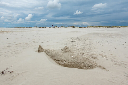 Sand sculpture of sawfish or shark on Kniepsand beach, Wittdun on Amrum island, North Frisia, Schleswig-Holstein, Germany