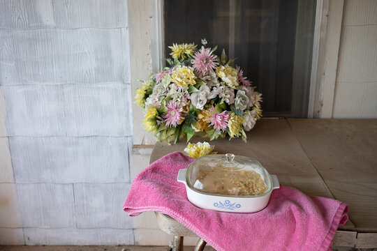 casserole and flowers on table
