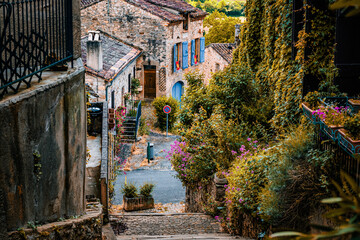 Old cobblestone medieval stairs with a view on the road in the town, the village of Cordes-Sur-Ciel in France