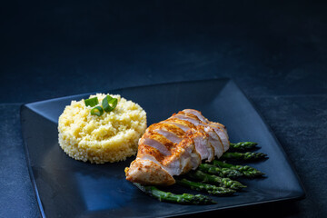Green asparagus with grilled chicken fillet and couscous