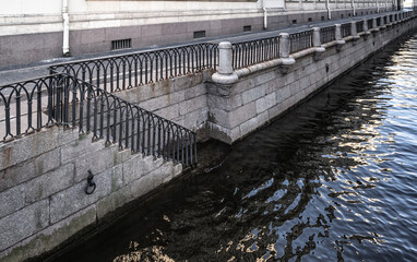 Granite embankment with stairs leading to the water.
