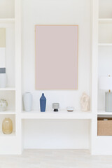 white shelf with blank art frame and vase