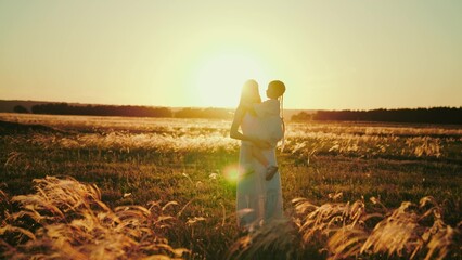 Family of girl and mom shares words of love strolling across park in light of setting sun. Family...