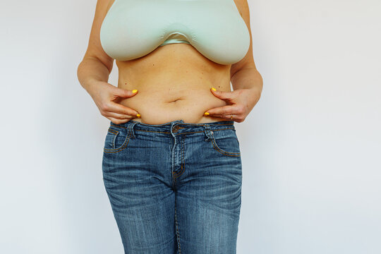 Overweight woman showing fat belly