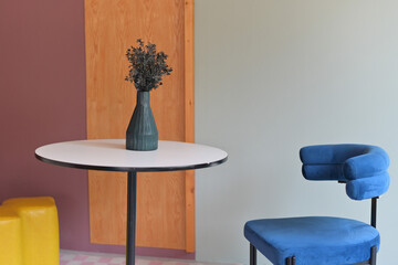 cozy home interior with modern furniture and stylish decor. Add touch of nature with orange and artificial floral bouquet in white vase. luxury and relaxation in residential concept.