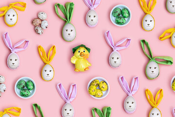 Cute Easter eggs with colorful Bunny Ears and smile on faces on Pink Background, Creative Flat lay...