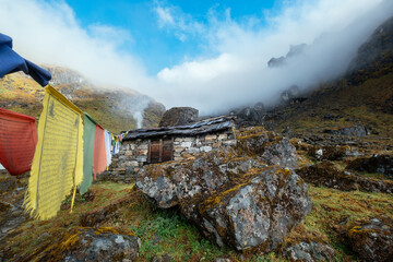 Traditional Himalayan architecture. Holy Buddhists praying multicolored flags with mantras flapping...