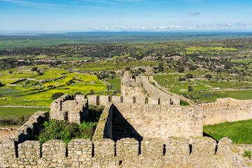 Walls of the medieval castle of Trujillo with the mountainous landscape in the background, Spain.