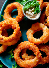 fried onion rings with sauce. selective focus.