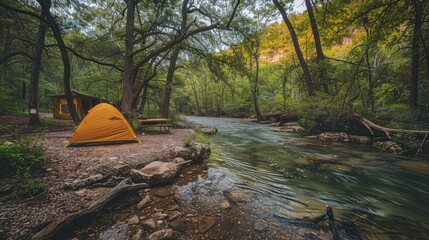 A camping riverside campsite with a lush green forest 