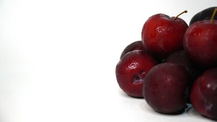 Fresh red plums isolated on a white background