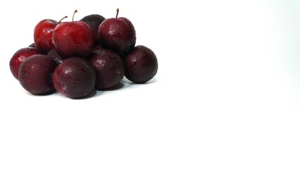 Fresh red plums isolated on a white background