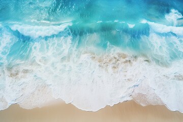 Fototapeta na wymiar Waving Ocean Waves on the Beach! Beautiful Natural Vacation Background with Aerial Top Down View of Blue Water Sea Waves in Summer Holiday Season