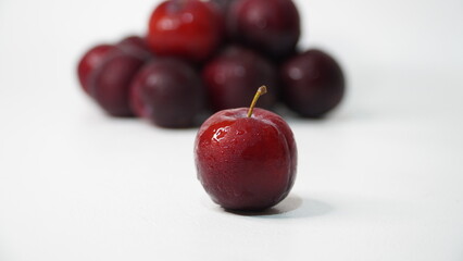Fresh red plums isolated on a white background