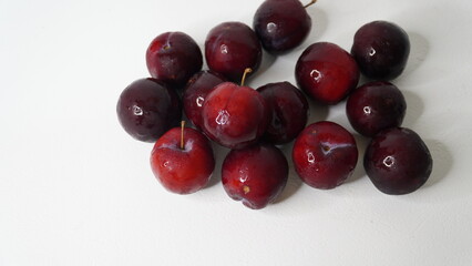 Fresh red plums isolated on a white background
