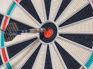 dart board with darts. dart in the target. concept hitting the target