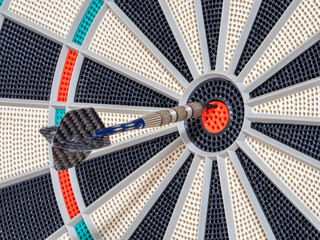 dart board with darts. dart in the target. concept hitting the target