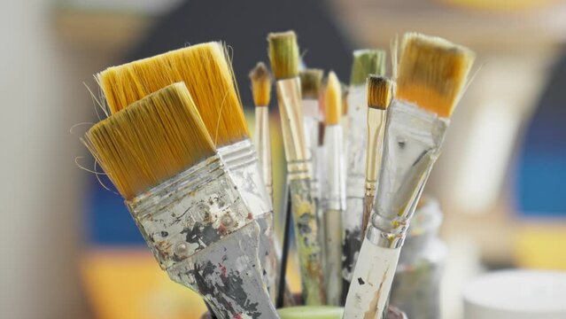 Paintbrushes in glass. Art concept. Close-up of artist tools. Brushes for painting. 4K, UHD