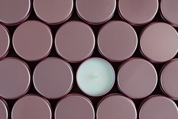 A pattern of jars with closed candles and one open candle