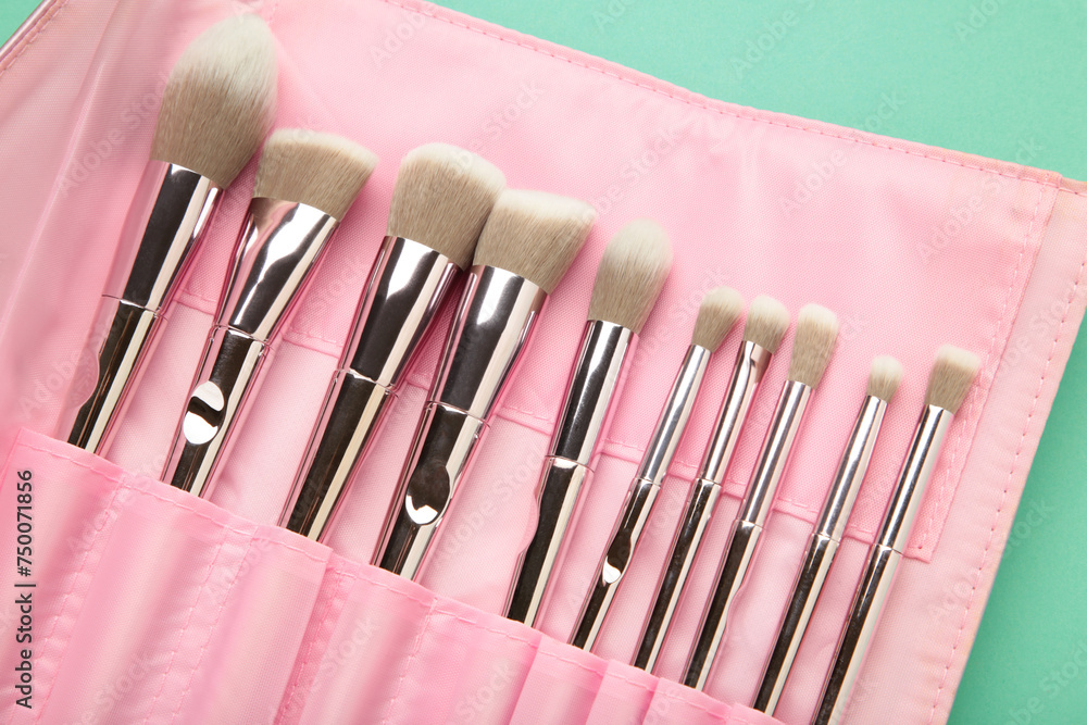 Wall mural makeup brushes in pink cosmetic bag. macro photo