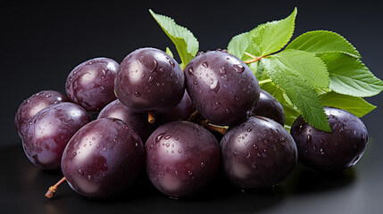 Dark violet plum with green leaves. Concept of healthy food