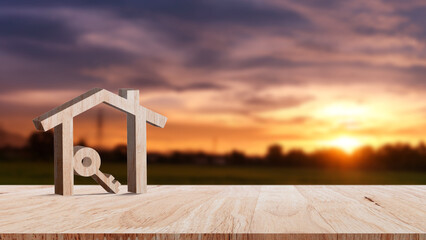 Mockup wooden house and key on wooden table, concept of real estate investment. Planning savings...