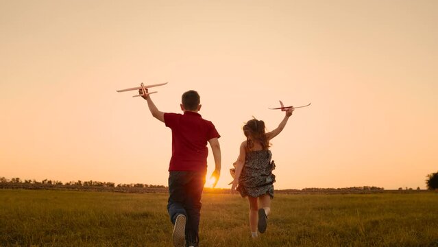happy boy girl child play airplane pilot sunset, children family dream flying, school bell rings, imagination carries children sky, jump, values teamwork, building memories, join us this adventure