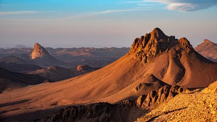 Foto op Aluminium Donkergrijs Hoggar landscape in the Sahara desert, Algeria. A view from Assekrem of the mountains and basalt organs that rise up in the morning light.