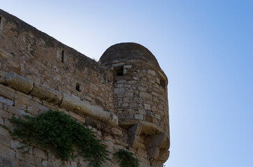 Corner tower of the Venetian Fortezza castle against the sky
